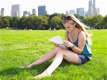 reflection reading newspaper - Woman reading a letter in central park Stock Photo - Premium Royalty-Free, Code: 649-03796728