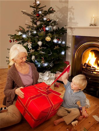 families opening presents at christmas - Grandson opens a present with his Granny Stock Photo - Premium Royalty-Free, Code: 649-03796849