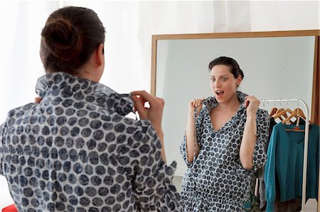 dressing mirror - woman looking in mirror Stock Photo - Premium Royalty-Free, Code: 649-03796982