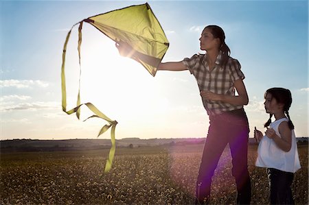 daughter sun - Mother and daughter playing with kite Stock Photo - Premium Royalty-Free, Code: 649-03797004