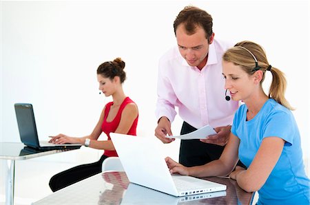 person standing and talking on phone - Colleagues  discuss data in office Stock Photo - Premium Royalty-Free, Code: 649-03797548