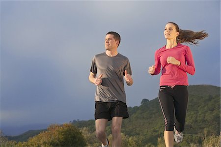 exercise and low angle - Young couple jogging in rural setting Stock Photo - Premium Royalty-Free, Code: 649-03797700
