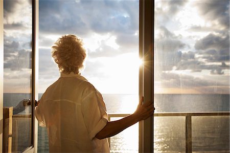 senior woman alone from behind - Senior Woman watching sunrise Stock Photo - Premium Royalty-Free, Code: 649-03816888