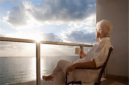 senior woman drinking coffee - Senior Woman watching sunrise Stock Photo - Premium Royalty-Free, Code: 649-03816889