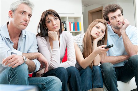 friends watching tv - Bored friends watching at TV Stock Photo - Premium Royalty-Free, Code: 649-03817383