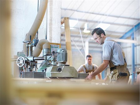 Woodworkers with planing machine Stock Photo - Premium Royalty-Free, Code: 649-03817811