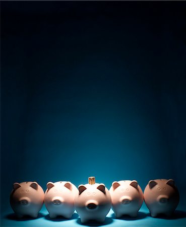Line of piggy banks one with coins on it Stock Photo - Premium Royalty-Free, Code: 649-03818007