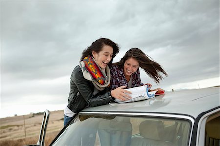 reading teenager - Friends looking in map Stock Photo - Premium Royalty-Free, Code: 649-03818219