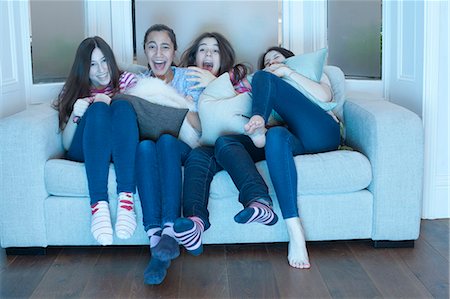 film - teenage girls watching tv on sofa Stock Photo - Premium Royalty-Free, Code: 649-03818428