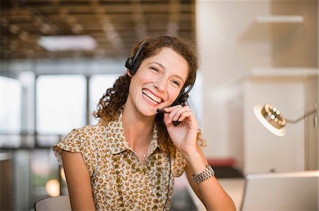 electronic sales - Smiling woman wearing headset Stock Photo - Premium Royalty-Free, Code: 649-03857199