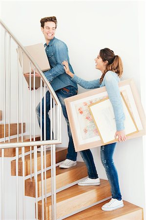 Couple moving boxes upstairs in new home Stock Photo - Premium Royalty-Free, Code: 649-03857366