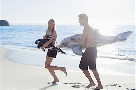 romantic husband carries wife images - Couple playing with toys on beach Stock Photo - Premium Royalty-Free, Code: 649-03857492