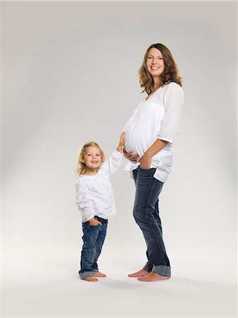 silhouette child - Girl rubbing pregnant mother's belly Stock Photo - Premium Royalty-Free, Code: 649-03857516