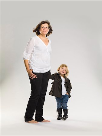 fashion women white background - Older woman holding granddaughter's hand Stock Photo - Premium Royalty-Free, Code: 649-03857519