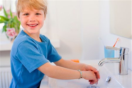 Boy washing his hands Stock Photo - Premium Royalty-Free, Code: 649-03857844