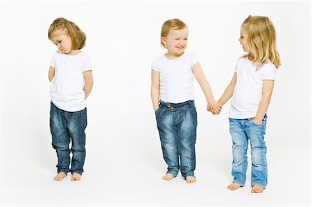 frustrated child white background - Two girls holding hands, third upset Stock Photo - Premium Royalty-Free, Code: 649-03857884