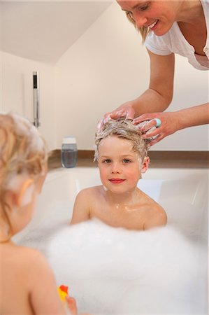 Mother washing son's hair in bathtub Stock Photo - Premium Royalty-Free, Code: 649-03857883