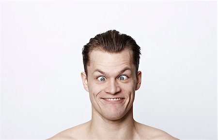 funny happy adult portrait - Nude man making a funny face Stock Photo - Premium Royalty-Free, Code: 649-03858016