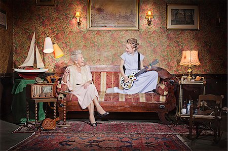 entertainer retro - Girl playing guitar for grandmother Stock Photo - Premium Royalty-Free, Code: 649-03858054