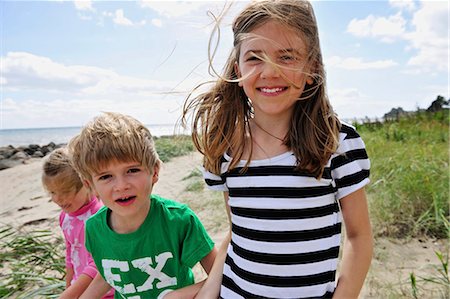 portrait of a boy and his sister standing on the beach - Children walking on beach together Stock Photo - Premium Royalty-Free, Code: 649-03858357