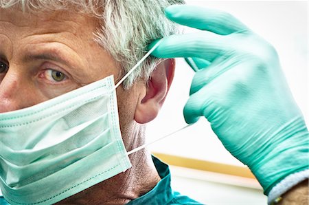 rubber glove - Dentist putting on face mask Stock Photo - Premium Royalty-Free, Code: 649-03858786