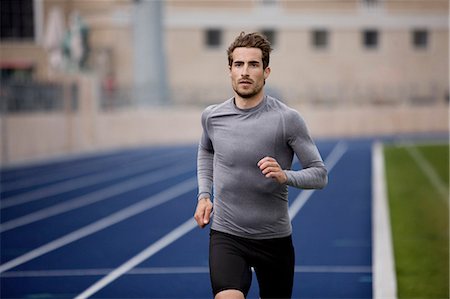 runners track - Man running on track Stock Photo - Premium Royalty-Free, Code: 649-03884131