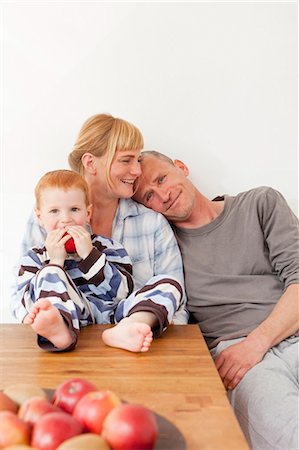 pyjamas (sleepwear with pants) - Family relaxing at table together Stock Photo - Premium Royalty-Free, Code: 649-03884171