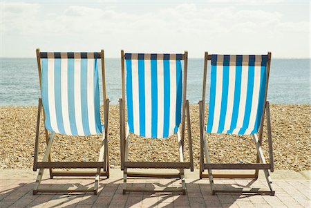 row of beach chairs - Striped lawn chairs on beach Stock Photo - Premium Royalty-Free, Code: 649-03884270