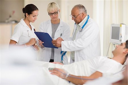 Doctors and nurse with hospital patient Stock Photo - Premium Royalty-Free, Code: 649-03881624