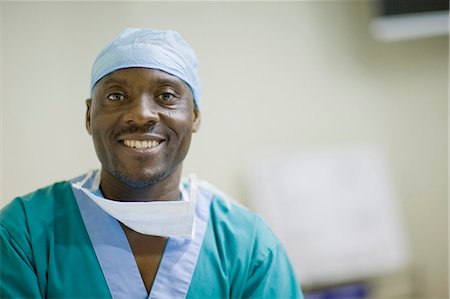 Smiling doctor with loosened mask Stock Photo - Premium Royalty-Free, Code: 649-03881675