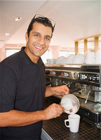 restaurant owner portrait - Man pouring foamed milk into coffee cup Stock Photo - Premium Royalty-Free, Code: 649-03881834