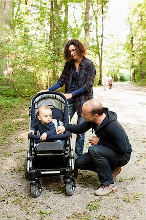 Family pushing baby in stroller Stock Photo - Premium Royalty-Free, Code: 649-03881867