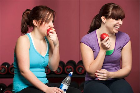 fruit with water - Women eating apples in gym Stock Photo - Premium Royalty-Free, Code: 649-03882007