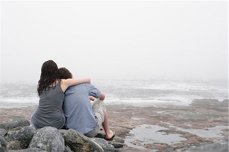 romantic images with backside - Couple hugging on rocky beach Stock Photo - Premium Royalty-Free, Code: 649-03882113