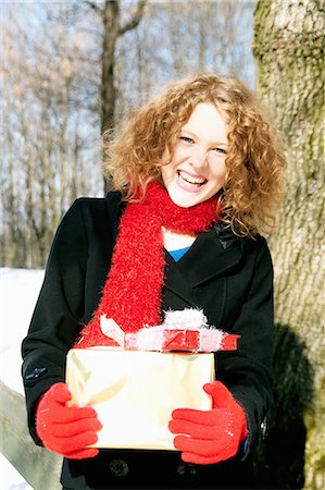 fun teenagers gifting - Girl carrying Christmas presents Stock Photo - Premium Royalty-Free, Code: 649-03882180