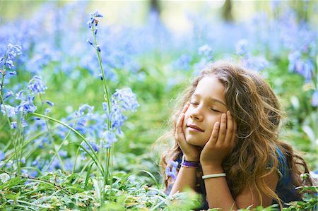 dreaming - Girl laying in field of flowers Stock Photo - Premium Royalty-Free, Code: 649-03882239