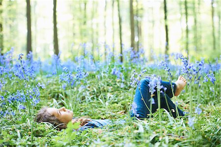 dreaming - Girl laying in field of flowers Stock Photo - Premium Royalty-Free, Code: 649-03882243