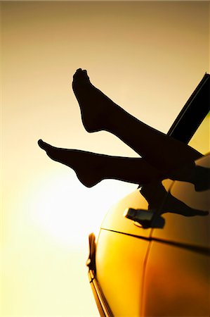 Woman's feet sticking out of car window Stock Photo - Premium Royalty-Free, Code: 649-03882334