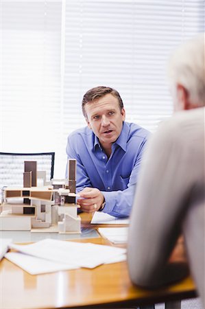 Business people examining model Stock Photo - Premium Royalty-Free, Code: 649-03882445