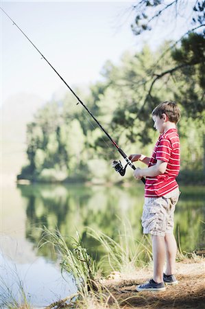 Boy fishing in lake Stock Photo - Premium Royalty-Free, Code: 649-03882533