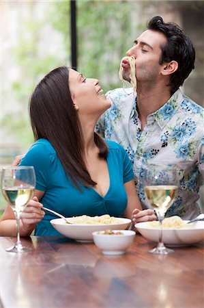 diverse people eating not illustration not monochrome and people - Playful couple eating together at table Stock Photo - Premium Royalty-Free, Code: 649-03882647