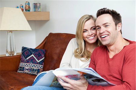 reading a magazine - Couple reading magazine together on sofa Stock Photo - Premium Royalty-Free, Code: 649-03882663