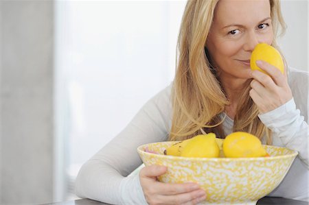 Woman smelling lemons Stock Photo - Premium Royalty-Free, Code: 649-03883163