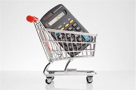 retail white background - Calculator in shopping cart Stock Photo - Premium Royalty-Free, Code: 649-03883417