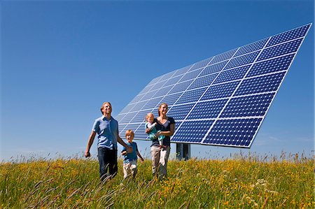 solar - Family walking in field by solar panel Stock Photo - Premium Royalty-Free, Code: 649-03883521