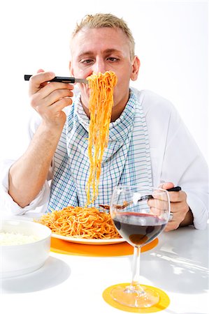 spaghetti table - Man eating plate of spaghetti Stock Photo - Premium Royalty-Free, Code: 649-03883638