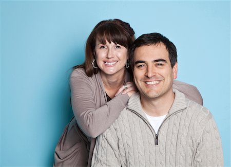 Portrait of happy couple, studio shot Stock Photo - Premium Royalty-Free, Code: 640-05760825