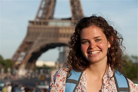 France, Paris, Portrait of young woman in front of Eiffel Tower Stock Photo - Premium Royalty-Free, Code: 640-05760885