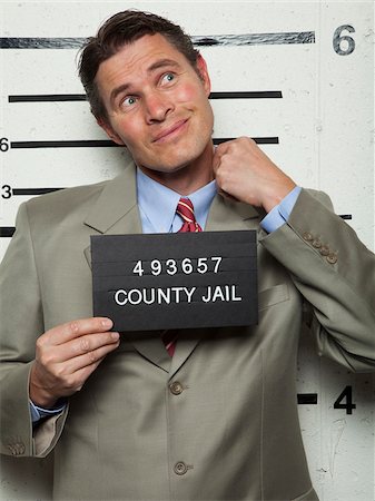 prison signage - Studio mugshot of businessman Stock Photo - Premium Royalty-Free, Code: 640-05760899