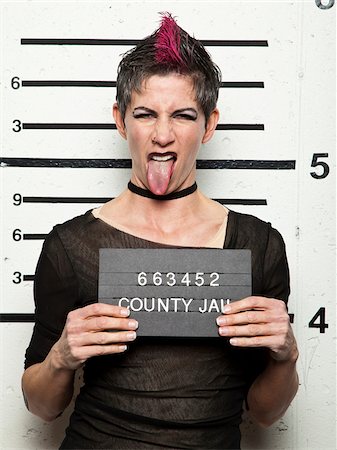 prison photograph - Studio mugshot of mature woman sticking out tongue Stock Photo - Premium Royalty-Free, Code: 640-05760901